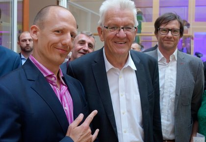2017 bei der Stallwächterparty in Berlin: Links Jörg Scheller, rechts Jochen Neuffer, Mitte Winfried Kretschmann. 