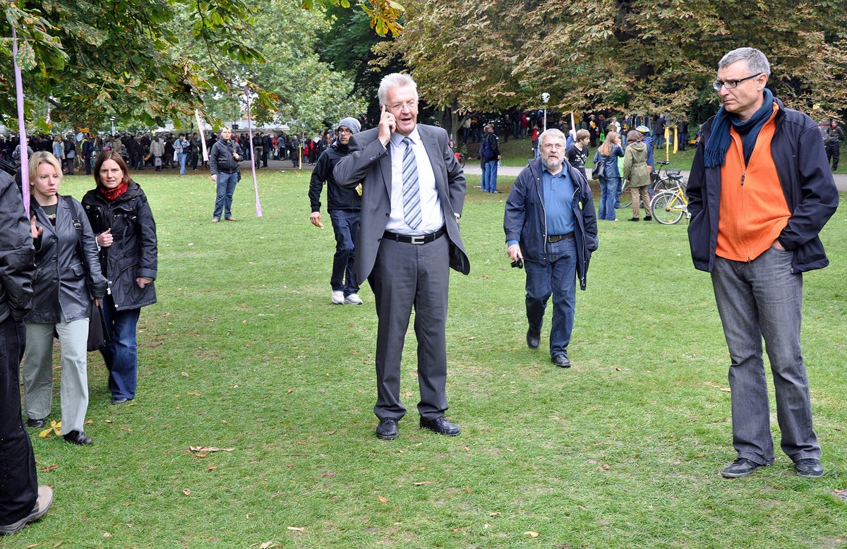 Auch der damalige grüne Fraktionschef und spätere Ministerpräsident Winfried Kretschmann kommt in den Park und versucht per Handy, Innenminister Rech an den Ort des Geschehens zu zitieren ("Kommen Sie sofort in den Schlossgarten!"). Vergeblich. Foto: Eberhard Scholz