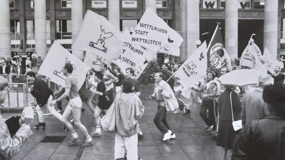 Winfried Hermann (Mitte mit Fahne) 1987 beim Lauf der Sportler für den Frieden, Schlossplatz Stuttgart. Foto: privat