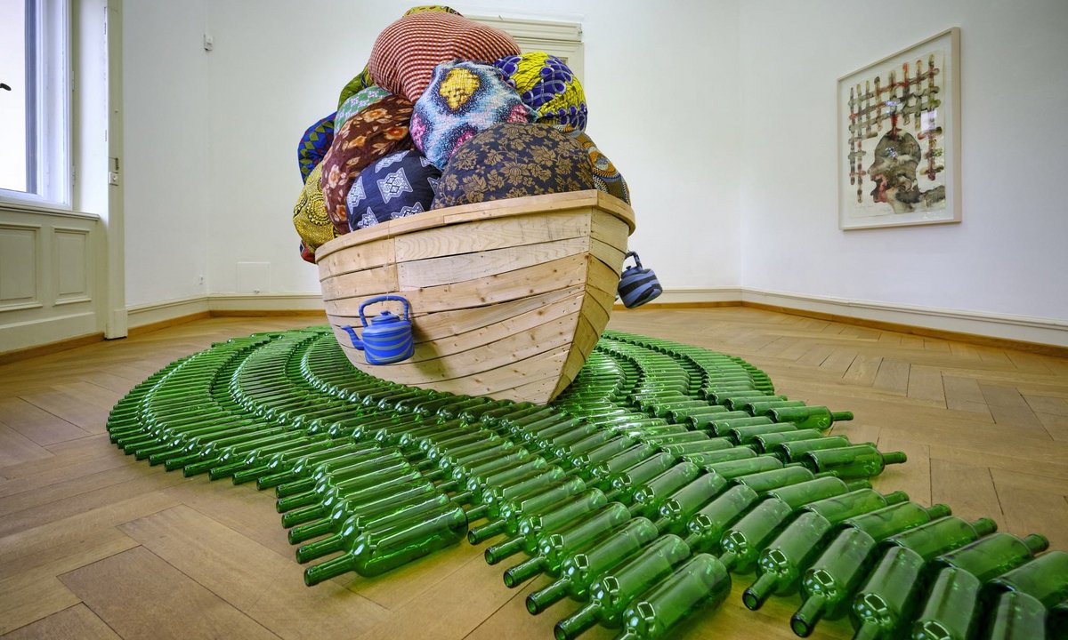 Ein überladenes Boot auf grünem Flaschenmeer spielt auf die Situation Flüchtender an. Ein überladenes Boot auf grünem Flaschenmeer spielt auf die Situation Flüchtender an.