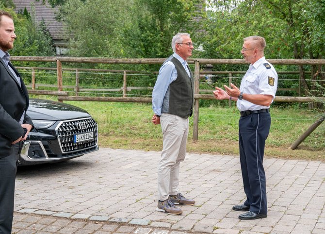 Der Personenwächter links guckt grimmig, Strobl und Anton Saile, Präsident des Polizeipräsidiums Einsatz, haben gute Laune.