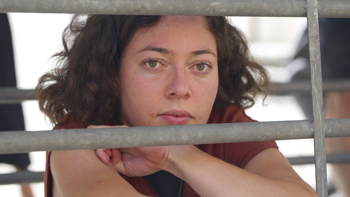 Auf dem Tübinger Holzmarkt: Elena Suck im Kastenstand, der heute noch üblichen Haltungsform für Muttersauen. Foto: Matthias Rude